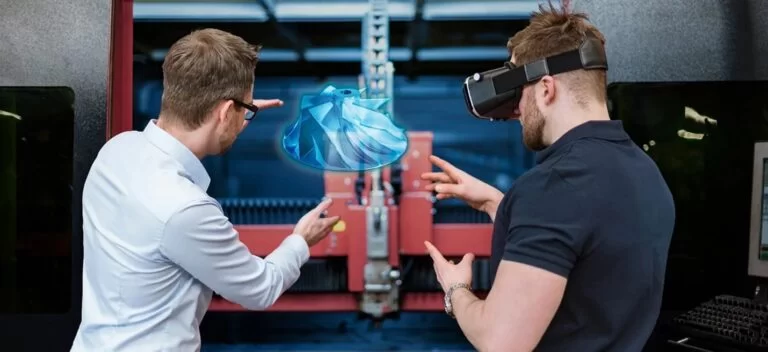 Two engineers collaborating in a modern manufacturing environment, with one using augmented reality glasses to visualize a 3D digital model of a component in front of a manufacturing machine.